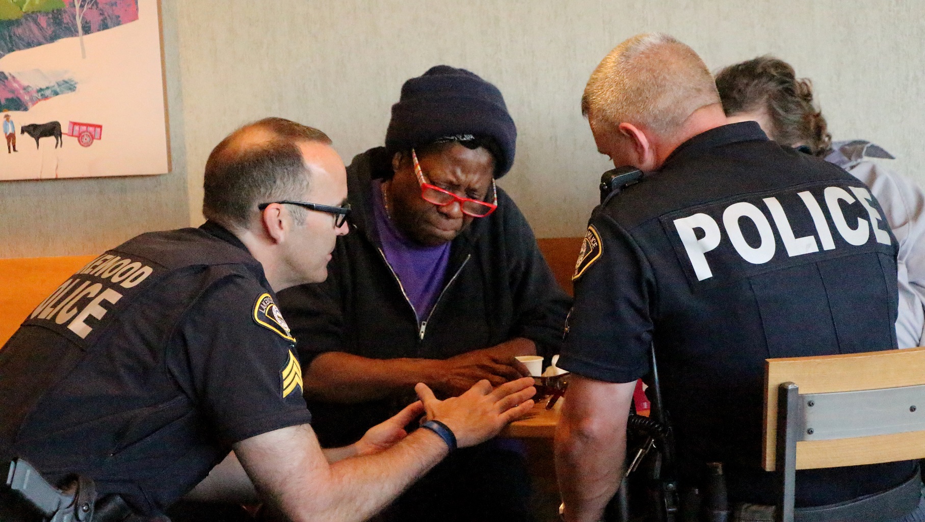 A Lakewood officer helps a resident with paperwork. 