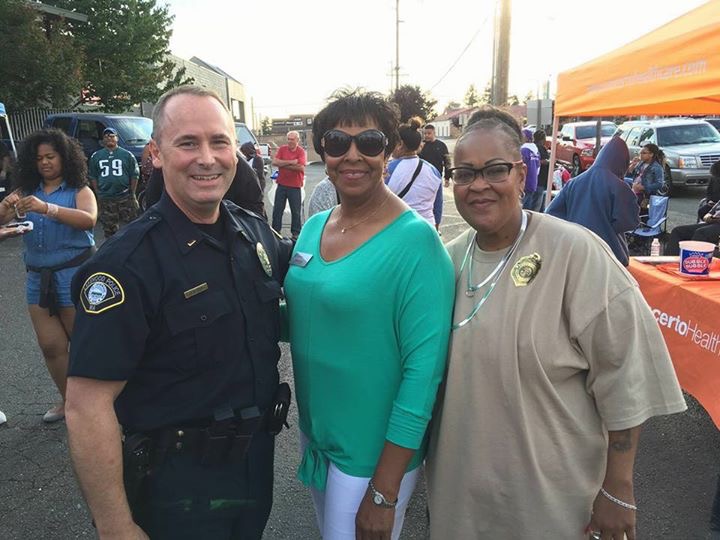 Deputy Mayor Mary Moss poses with a photo with an LPD officer and a resident. 