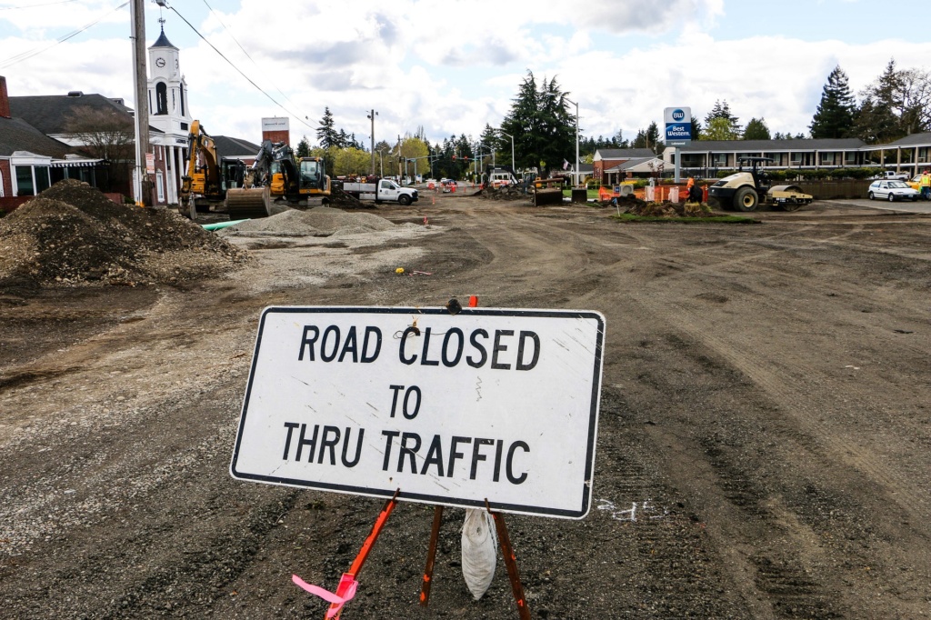 Photo of Road closed to thru traffic sign with construction in the background