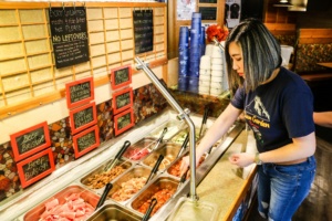 Cham Garden owner Kay Lim prepares the all you can eat section for diners at the Lakewood, WA restaurant that offers cozy Korean BBQ dining.