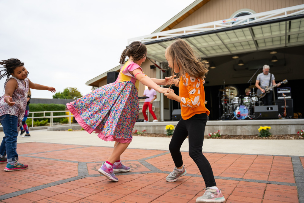 two children dance at the Summer Nights at the Pavilion summer concert series in Lakewood WA in July 2021.