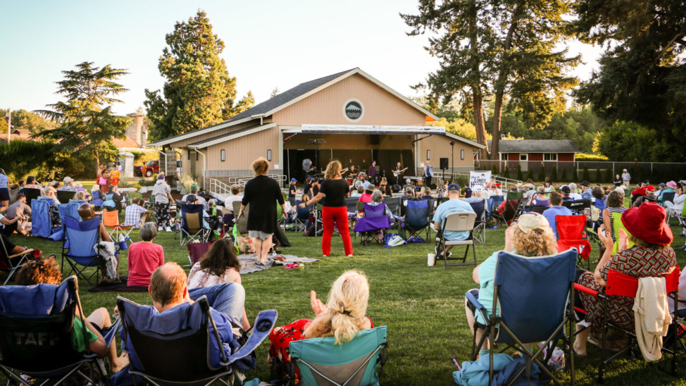 People dance in the field of The Pavilion at Fort Steilacoom Park for the City of Lakewood's Summer Nights at the Pavilion concert series.
