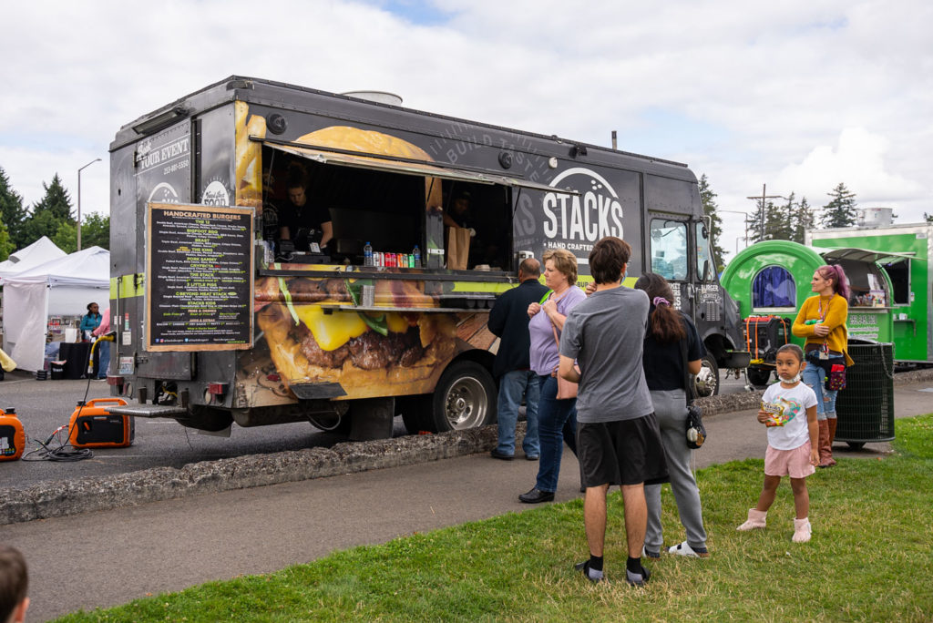 Customers wait for their food at a food truck at Lakewood's SummerFEST