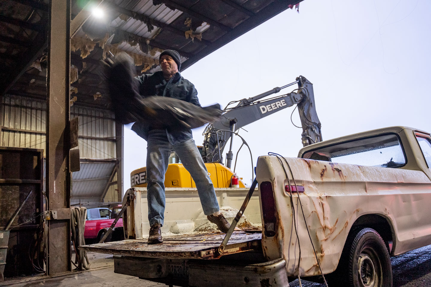 a person dumps items from the back of their truck at a city of lakewood community cleanup