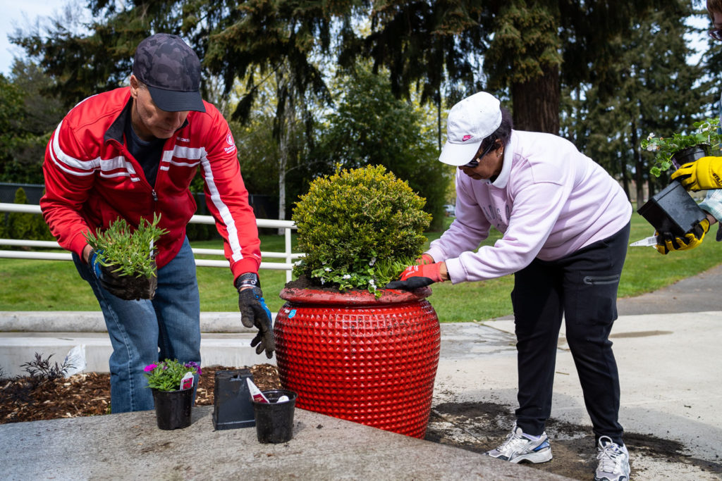 Mayor Jason Whalen and Deputy Mayor Mary Moss plant items in a planter for Parks Appreciation Day