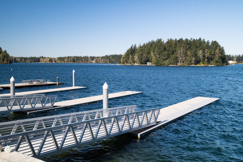 Three docks extending into the water at Harry Todd Park. 