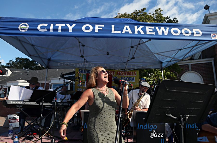 Woman singing in front of a City of Lakewood event tent in Lakewood, WA