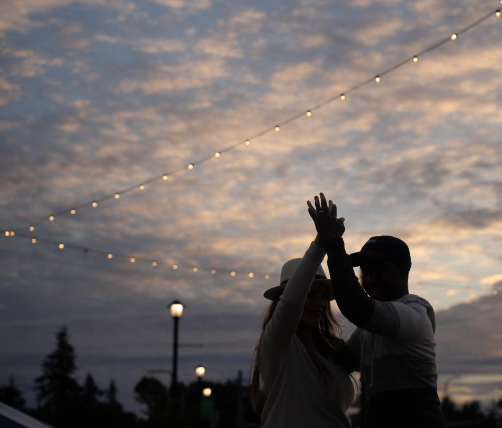 A couple dances against the setting sun at the Colonial Plaza in Lakewood.