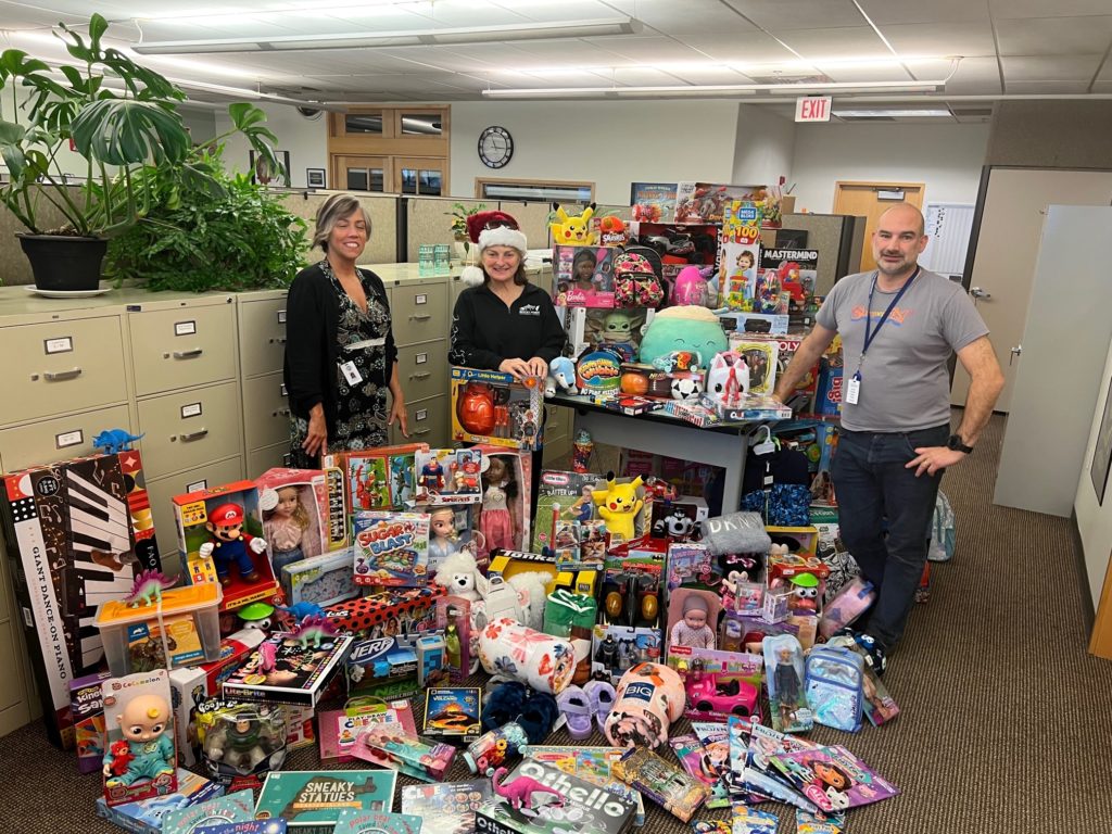 Lakewood Public Works Engineering Department employees pose with a selection of toys purchased to support Lakewood children during the holidays.