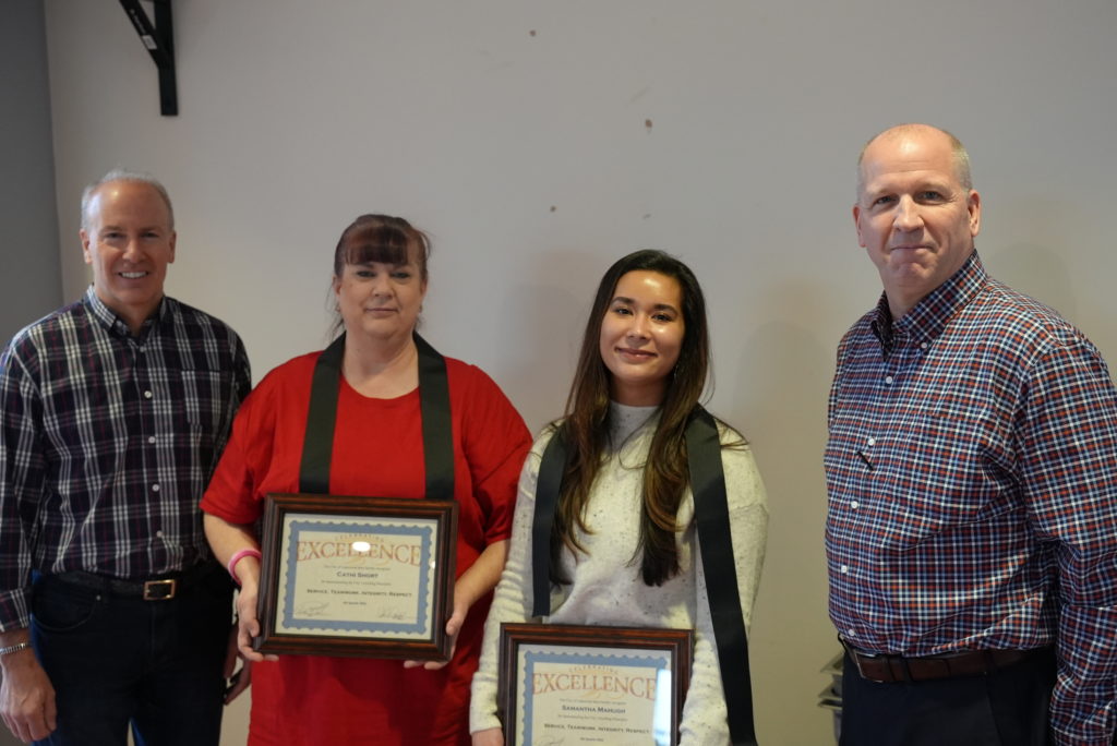 A picture of the Mayor and City Manager awarding Cathi Short and Samantha McHugh an Award of Excellence for outstanding work in Lakewood. 