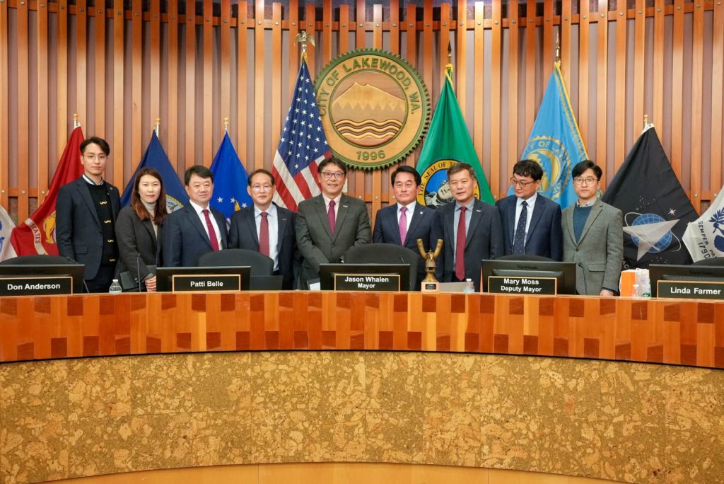 Representatives from Gimehae City in the Republic of South Korea pose on the Lakewood City Council dais.
