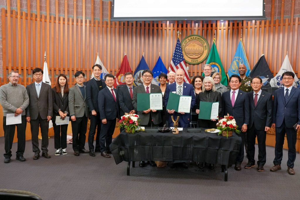 The city of Lakewood and Gimhae City signed an agreement Dec. 5, 2022 to become sister cities. Representatives from both cities pose for a photo in Lakewood City Council chambers.