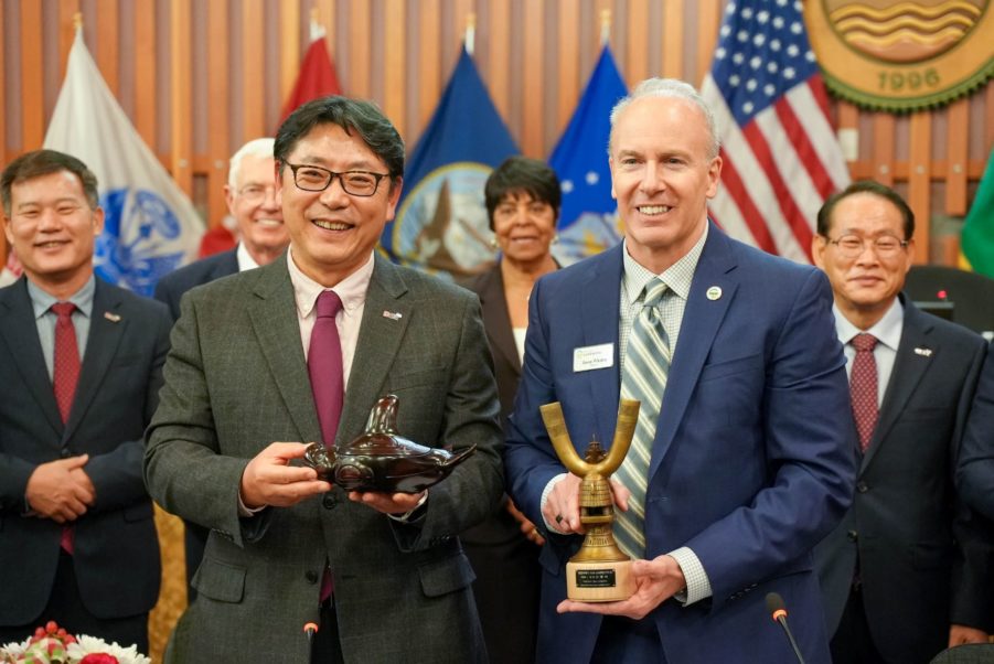 Lakewood Mayor Jason Whalen and Gimhae City Mayor Hong Tae-yong showcase gifts presented at a ceremony Dec. 5, 2022 in Lakewood Council Chambers.