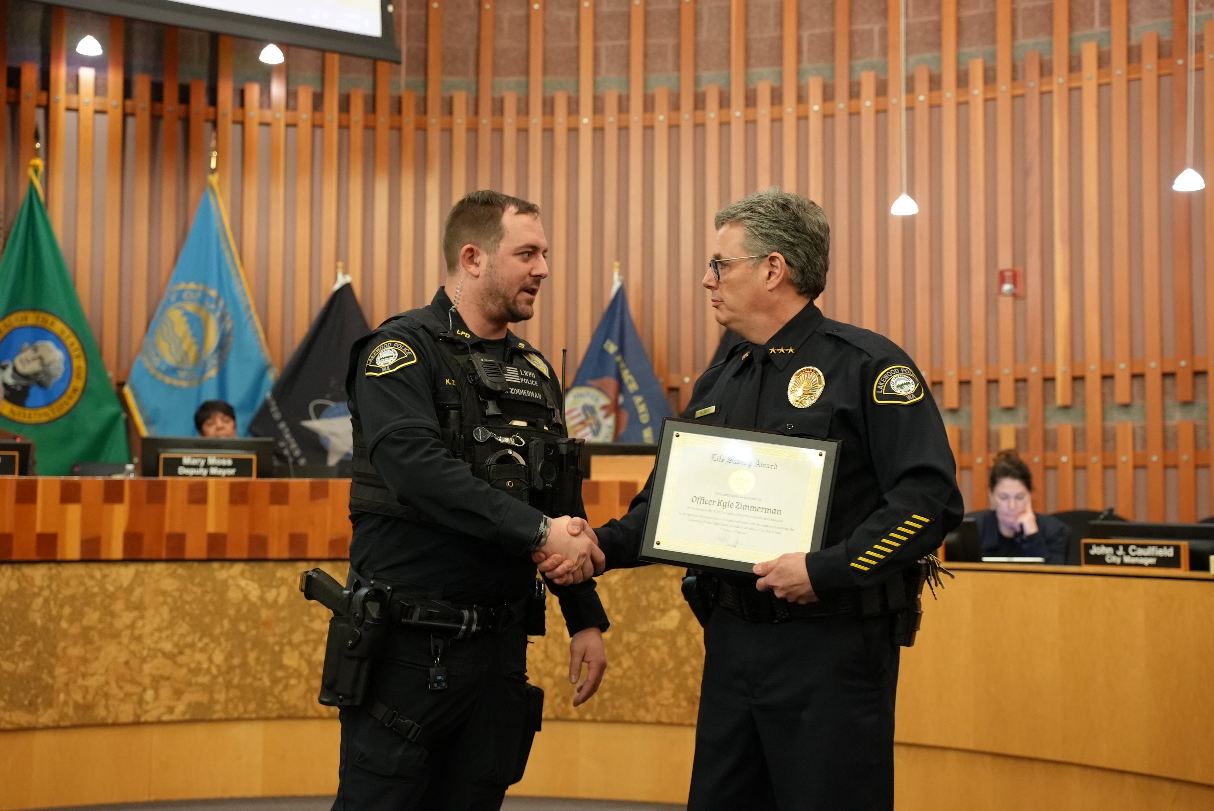 Officer Kyle Zimmerman receives a life-saving award from Chief Zaro.