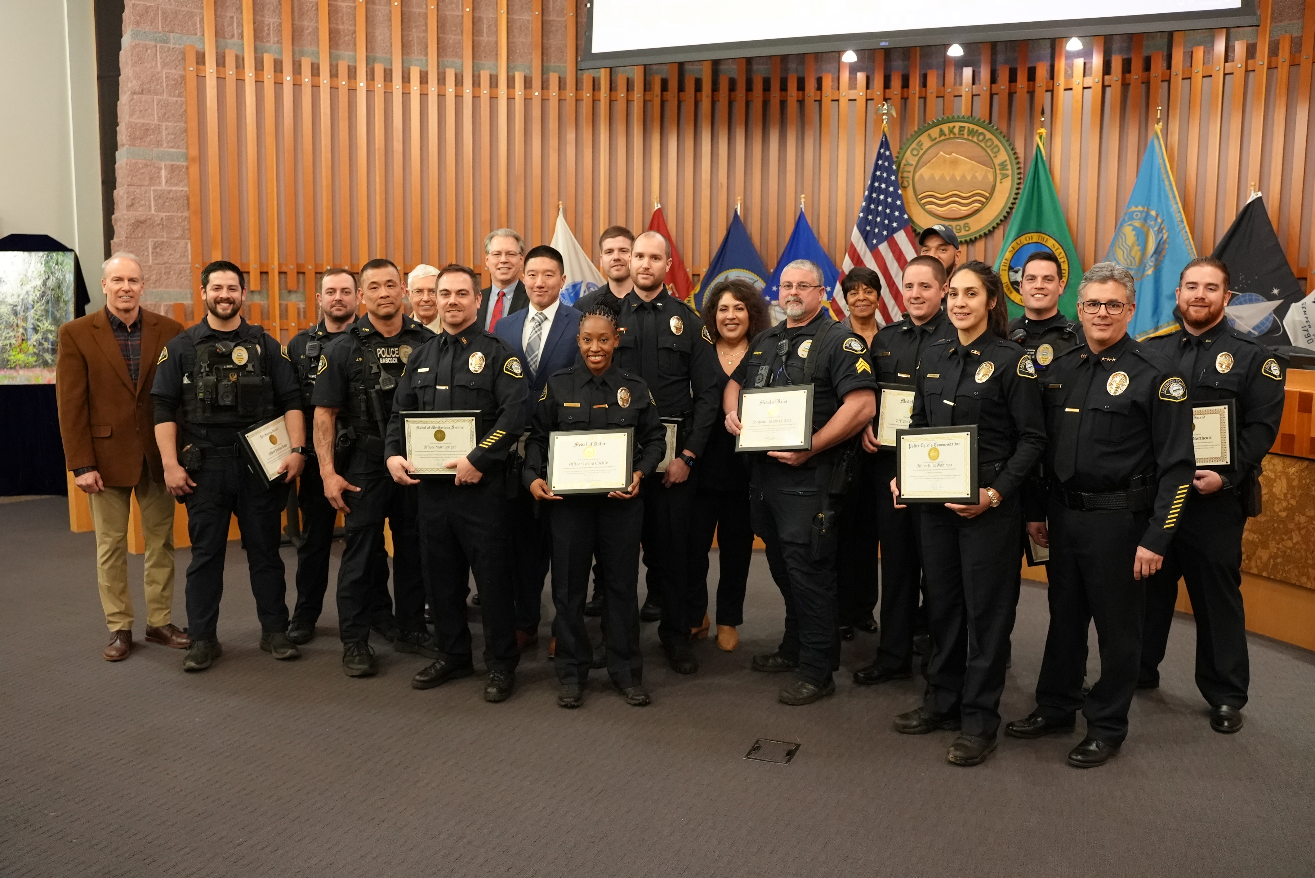 Lakewood police officers pose with City Council during their award ceremony.