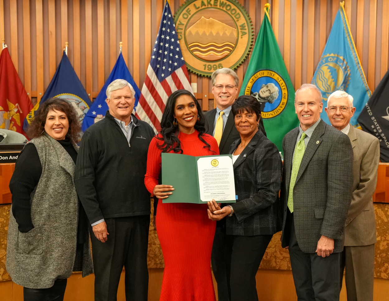 Mezzo-soprano opera singer J'Nai Bridges poses with the Lakewood City Council with a proclamation she was given by the city.