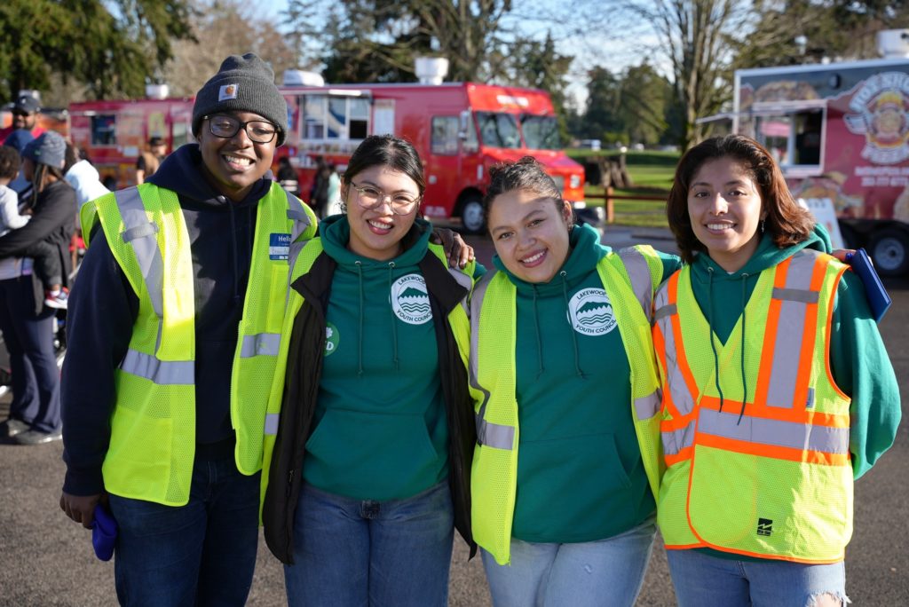 Four members of the Lakewood Youth Council wearing volunteer vests.