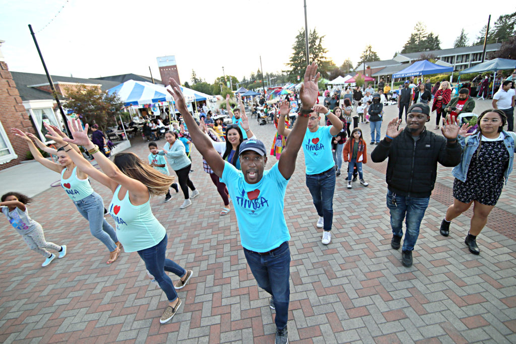 A group of people dance in the street at the City of Lakewood's Fiesta De La Familia in September 2022.