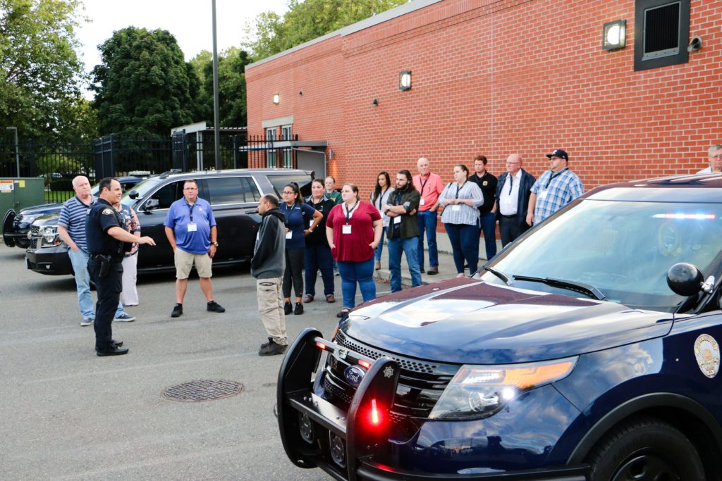 Lakewood police officer giving a tour of a police car