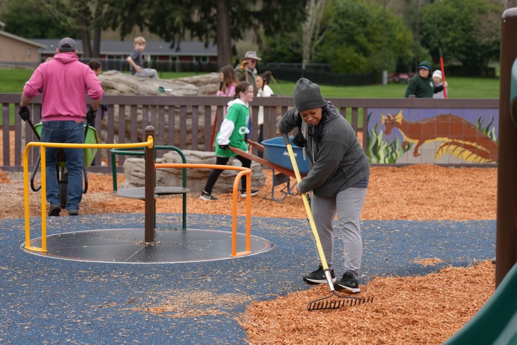 A volunteer spreads woodchips at the April 2023 Parks Appreciation Day in Lakewood.