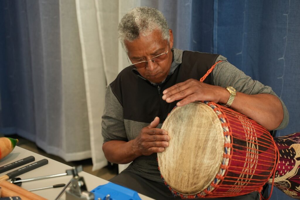 Lakewood Arts Commission member Darryl Owens plays a hand drum.