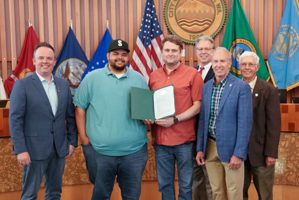 Members of the Oasis Youth Center join the Lakewood City Council to receive the 2023 June is Pride Month proclamation