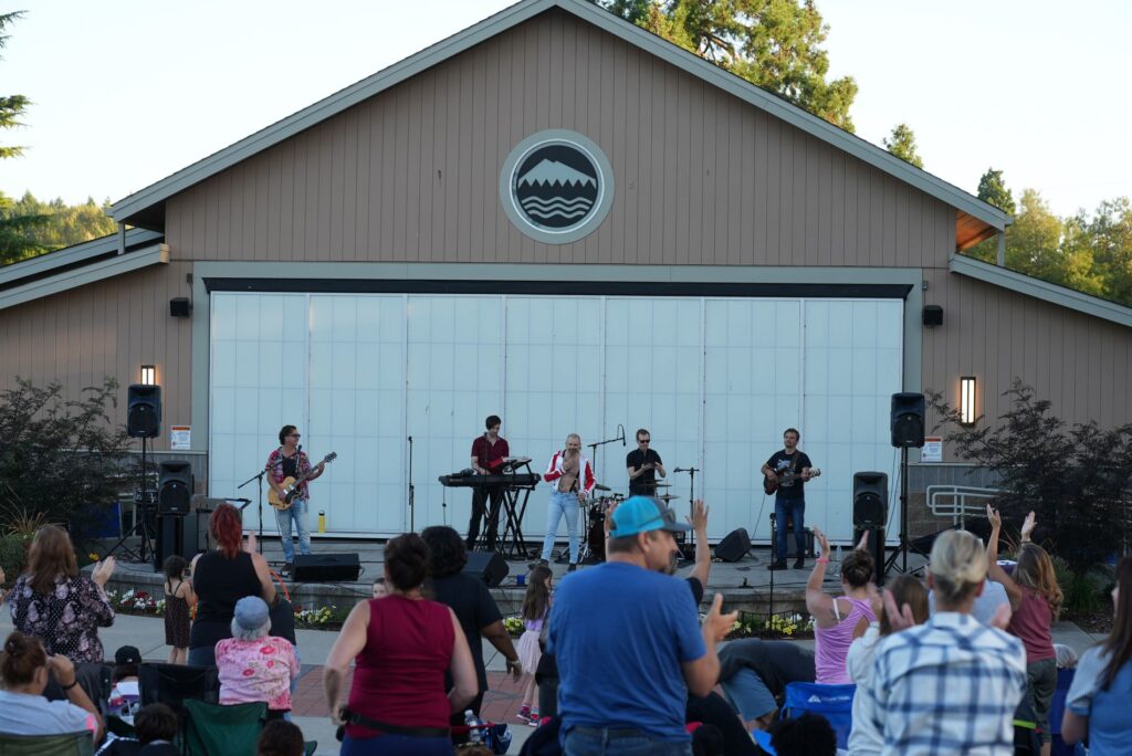 Queen Mother, a Queen tribute band, performs at The Pavilion in Fort Steilacoom Park on July 25, 2023 while the crowd stands on its feet to cheer and dance.