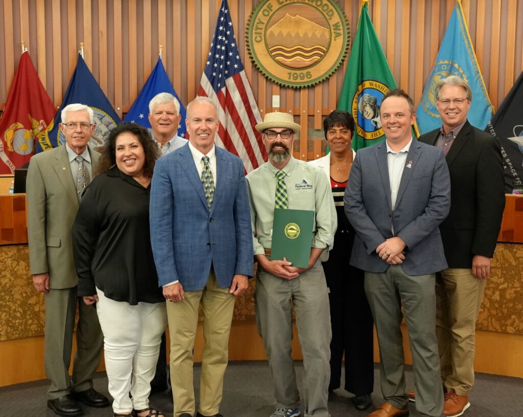 The Lakewood City Council stands in Council Chambers after awarding a proclamation for July 2023 being Parks and Recreation Month.