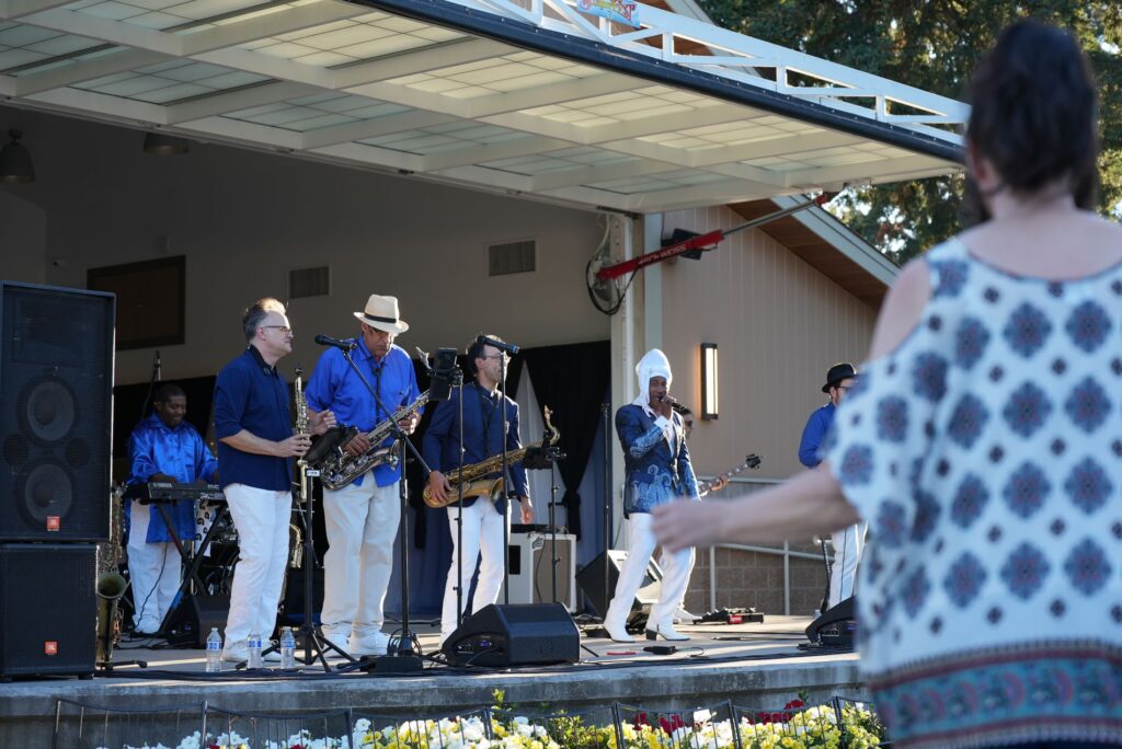 Members of the band Copastetic perform on the Lakewood Pavilion stage at a summer concert series in Fort Steilacoom Park in Lakewood, WA Aug. 15, 2023.