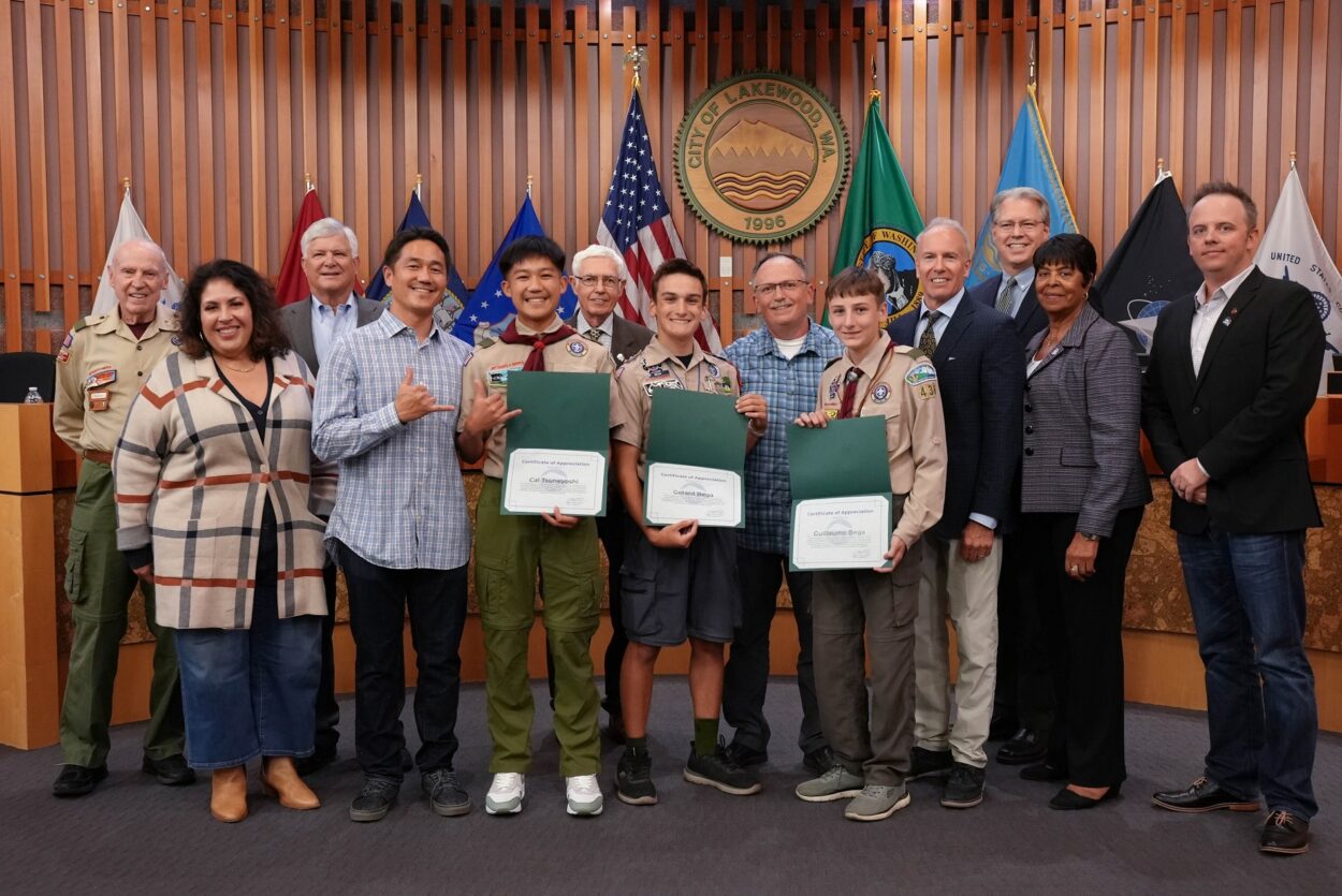 Eagle Scouts Cal Tsuneyoshi, Gerard Bega and Guillaume (Guy) Bega stand with the Lakewood City Council after receiving certificates of recognition for their volunteerism in the city.