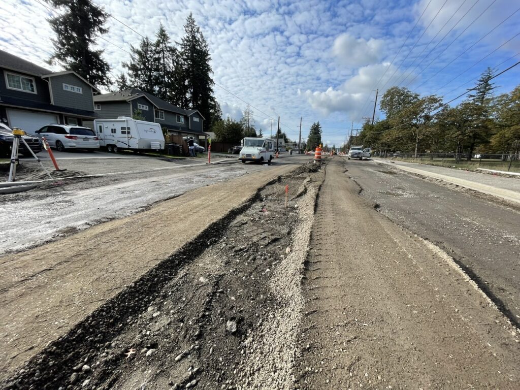 A picture looking down Washington Boulevard in Lakewood, WA in October 2023. The road is all dirt and under construction.