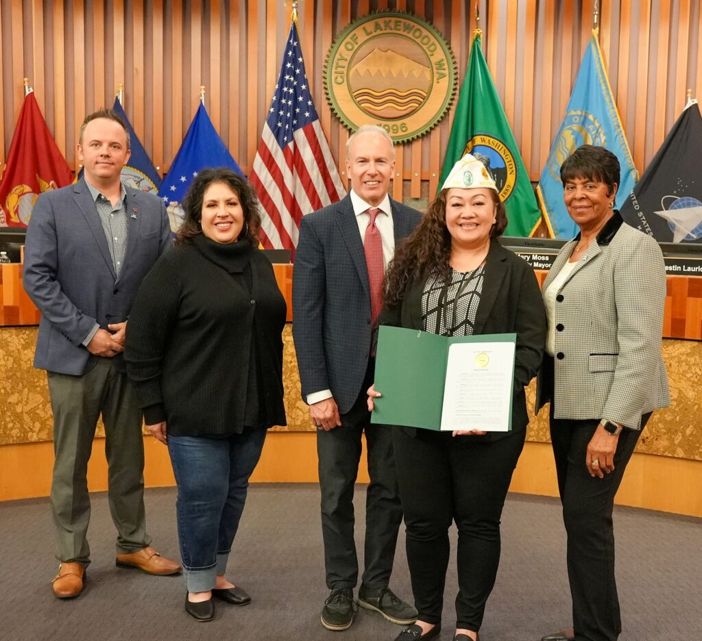 Members of the Lakewood City Council pose with Easter Iuli of the Department of Washington American Legion. Iuli accepted a proclamation on Operation Green Light.