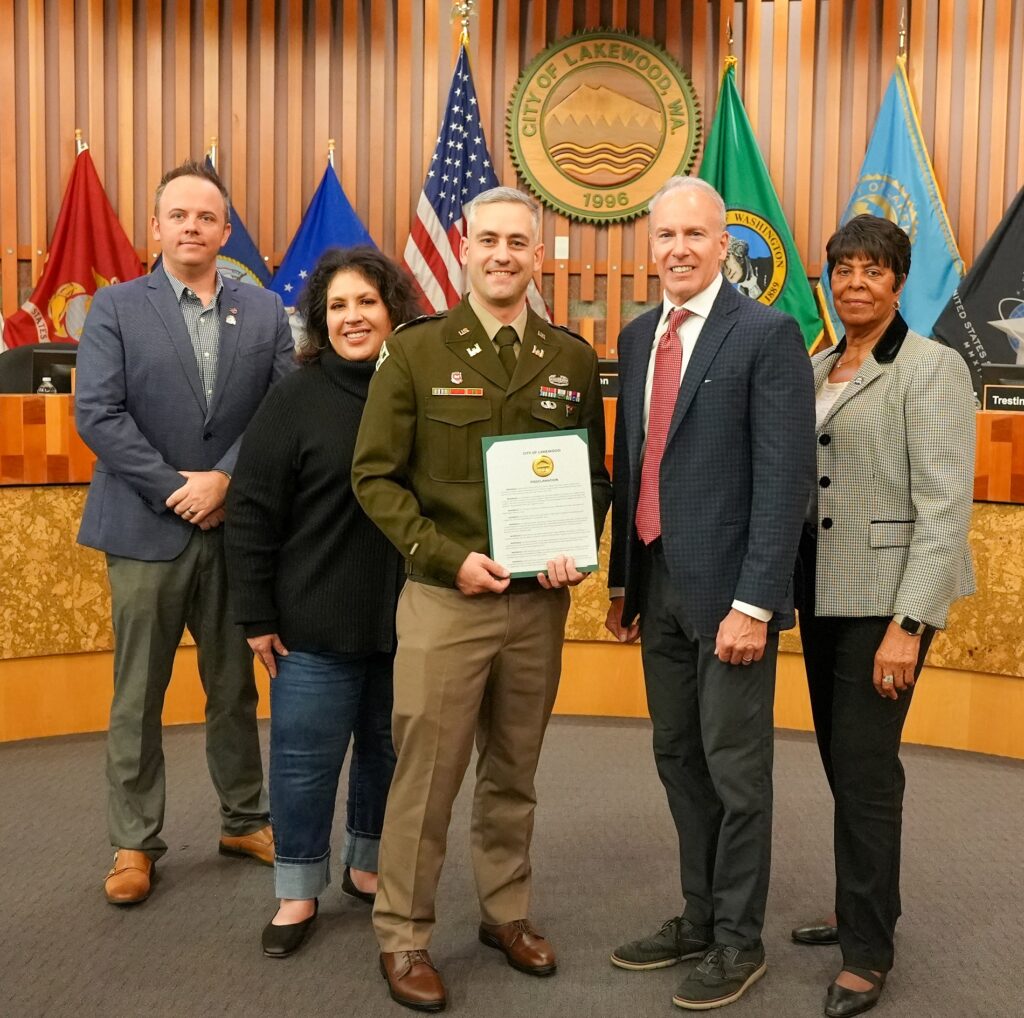 The Lakewood City Council poses with Maj. Brian Molloy, Brigade Executive Officer with the 2/2 Stryker Brigade out of JBLM. Molloy received a proclamation supporting veterans on Veterans Day.