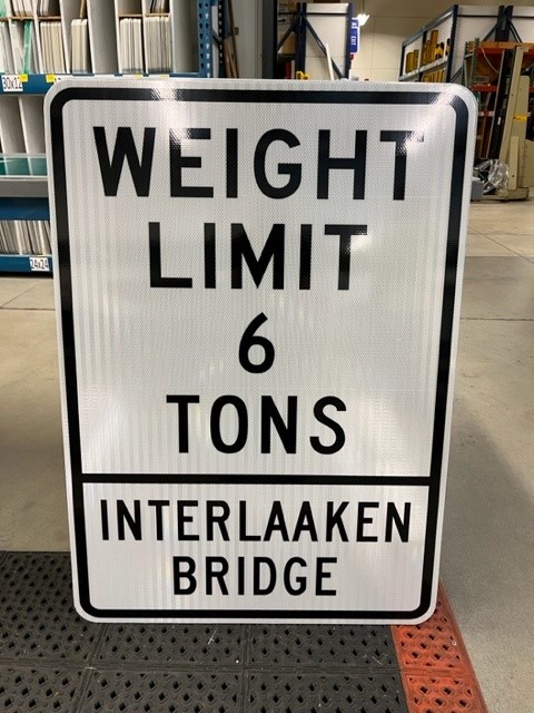 A photo of a weight limit sign that reads Weight Limit 6 tons Interlaaken Bridge.