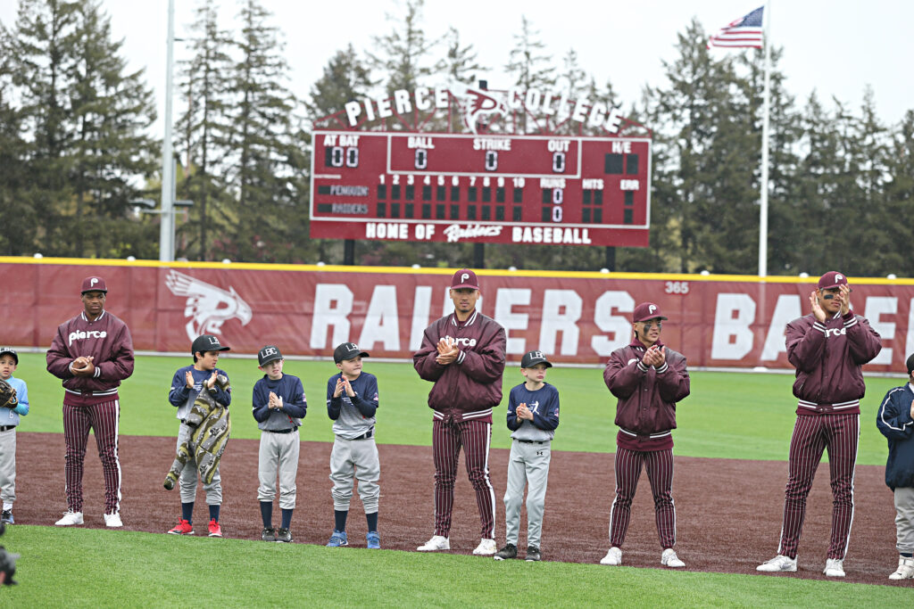 Pierce College Baseball players stand on the new field at Fort Steilacoom Park with Lakewood Baseball Club Little League players April 27, 2024