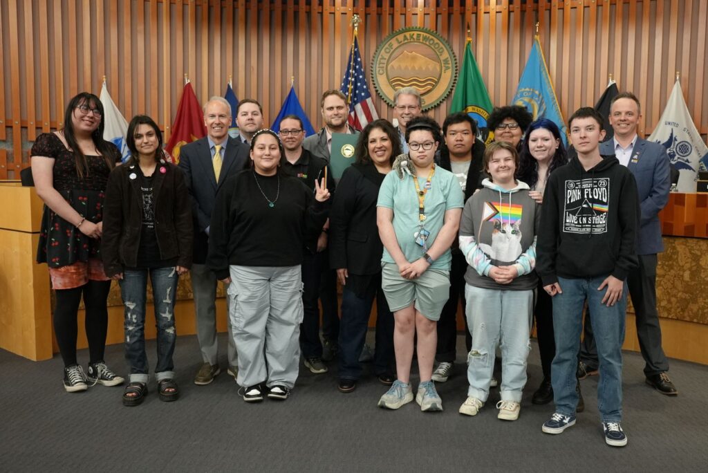 Representatives from Oasis Youth Center accept the June is LGBTQ+ Pride Month proclamation from the Lakewood City Council in 2024.