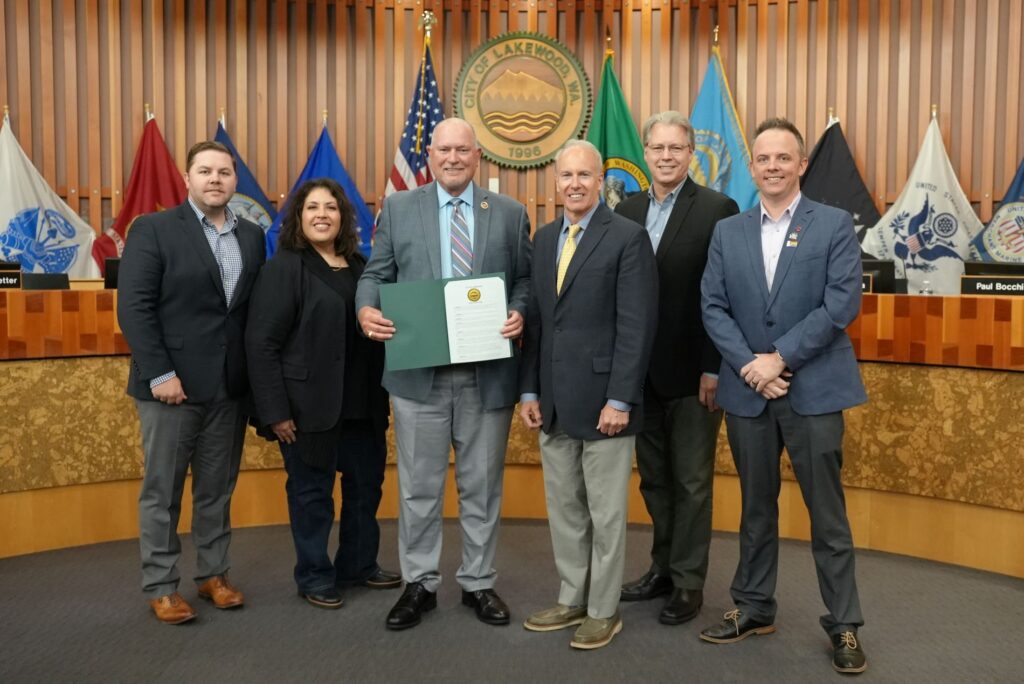 Pierce Transit CEO Mike Griffus poses with the Lakewood City Council to accept a proclamation for June being Ride Transit Month in 2024