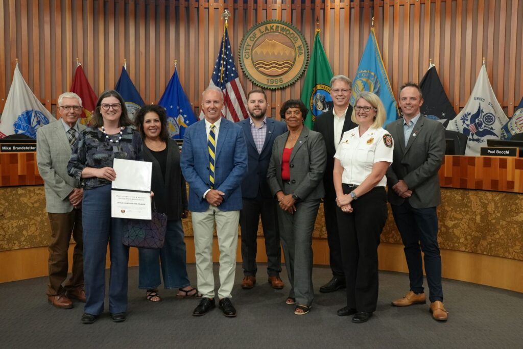 Members of the Lakewood City Council are joined by West Pierce Deputy Chief Hallie McCurdy and a representative from Little Church on the Prairie for a West Pierce recognition at the Aug. 19, 2024 council meeting.