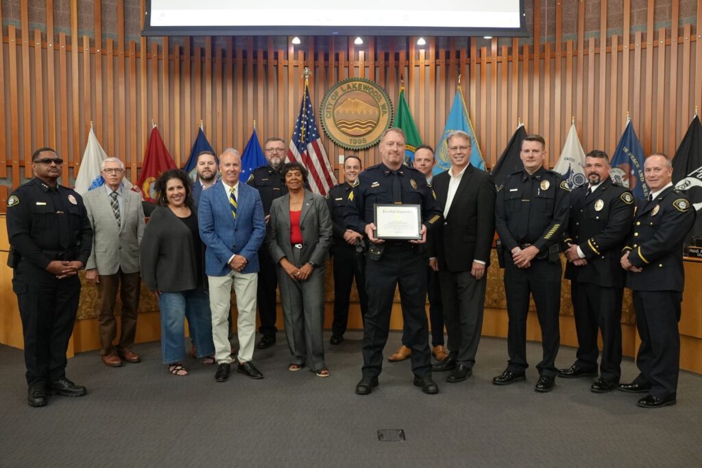 Sgt. Jeff Paynter poses with the Lakewood City Council and members of the Lakewood Police Department after receiving a recognition in August 2024.