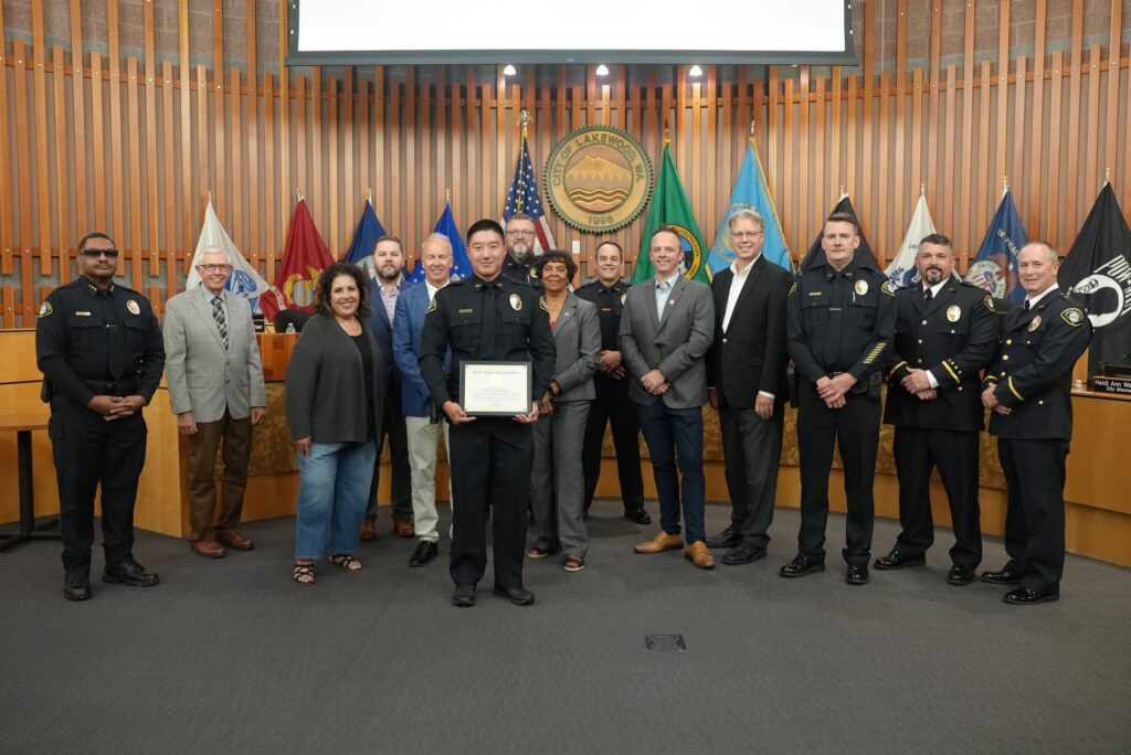 Officer Daniel Pyon poses with the Lakewood City Council and members of the Lakewood Police Department after receiving a recognition in August 2024.