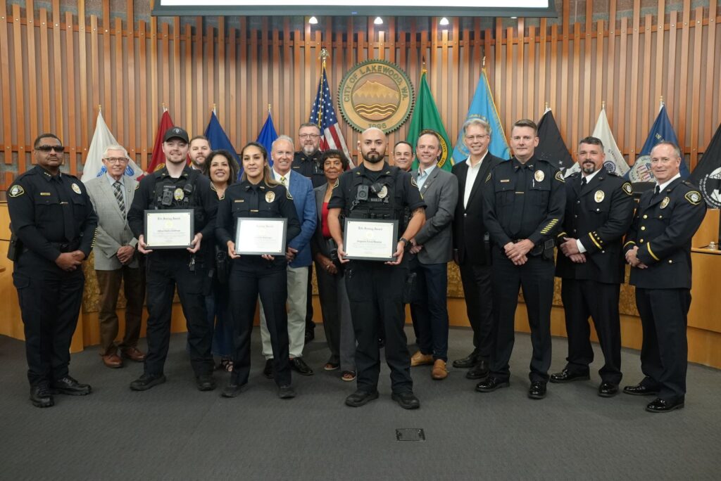 Officers Kirkham, Wabinga and Sgt. Mullen pose with the Lakewood City Council and members of the Lakewood Police Department after receiving a recognition in August 2024.