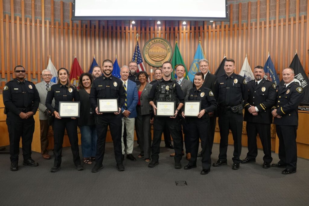 Lakewood Police officers Wabinga, Walker, Mahaffey and Bentz pose with members of the Lakewood City Council and Police Department after being recognized in August 2024.