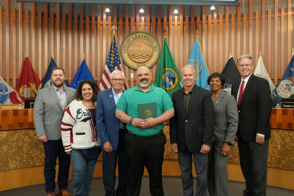 Chris Judd with Bur's Restaurant poses with members of the Lakewood City Council after accepting the September 2024 business showcase.