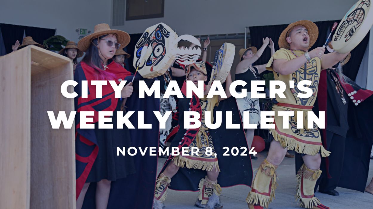 White text reads City Manager's Weekly Bulletin Nov. 8, 2024 over an image of people wearing traditional Native American clothing and performing a traditional Native American dance.