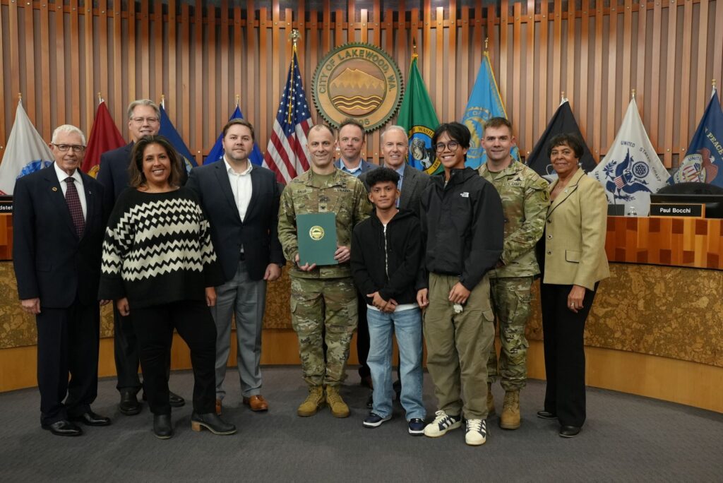 Members of the I Corps Command staff pose with the Lakewood City Council and two members of the Lakewood Youth Council after a proclamation recognizing Veterans Day was read.