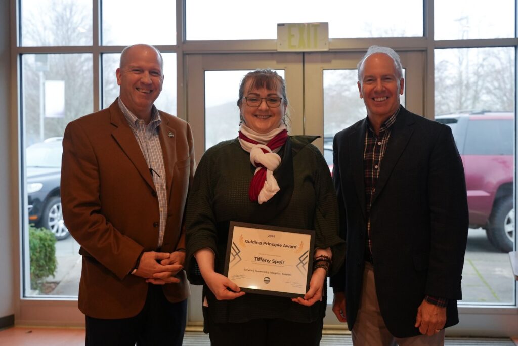 City Manager John Caulfield poses with Lakewood employee Tiffany Speir and Lakewood Mayor Jason Whalen after Speir was presented with a Guiding Principle award for her work in 2024.