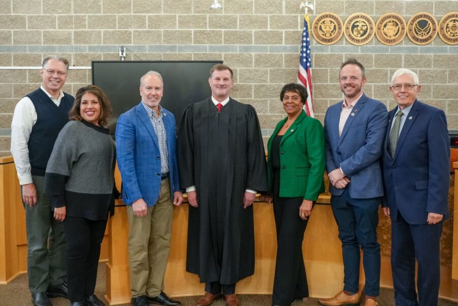 Lakewood Municipal Court Judge Tim Lewis poses in the courtroom with members of the Lakewood City Council after he was ceremoniously sworn into office on Dec. 2, 2024.