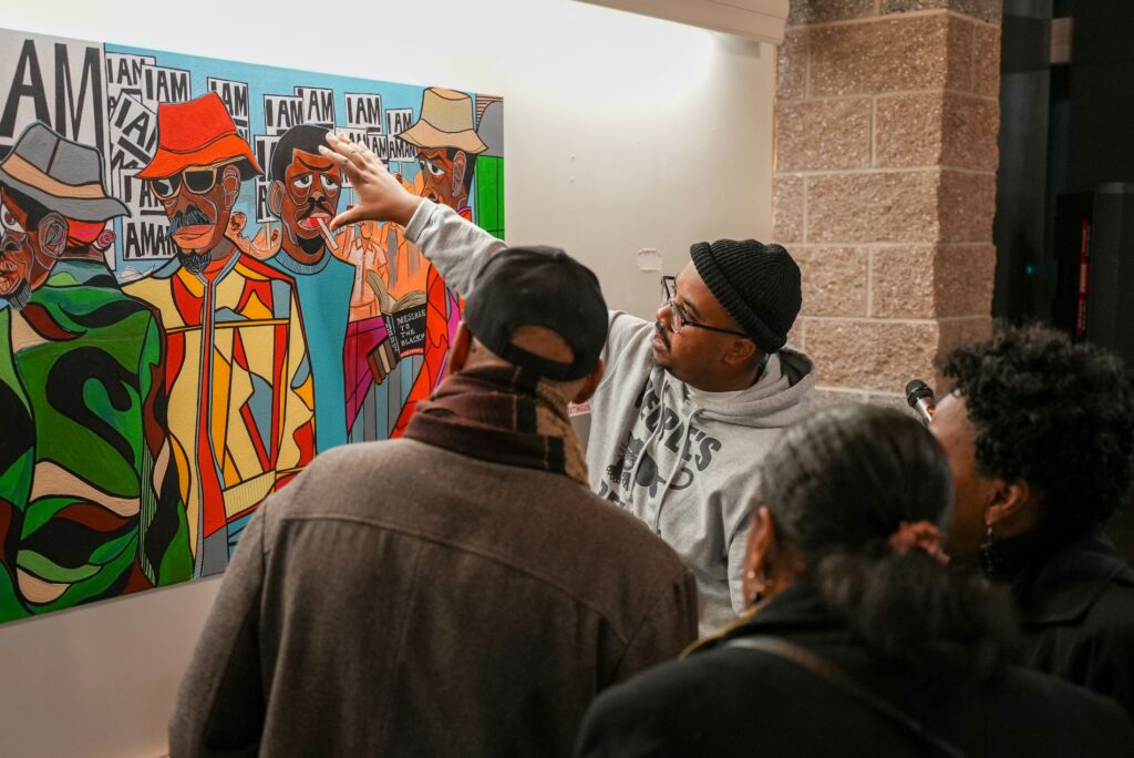 Local artist Rodney King showcases his artwork to a group of people at Lakewood City Hall on Jan. 13, 2025