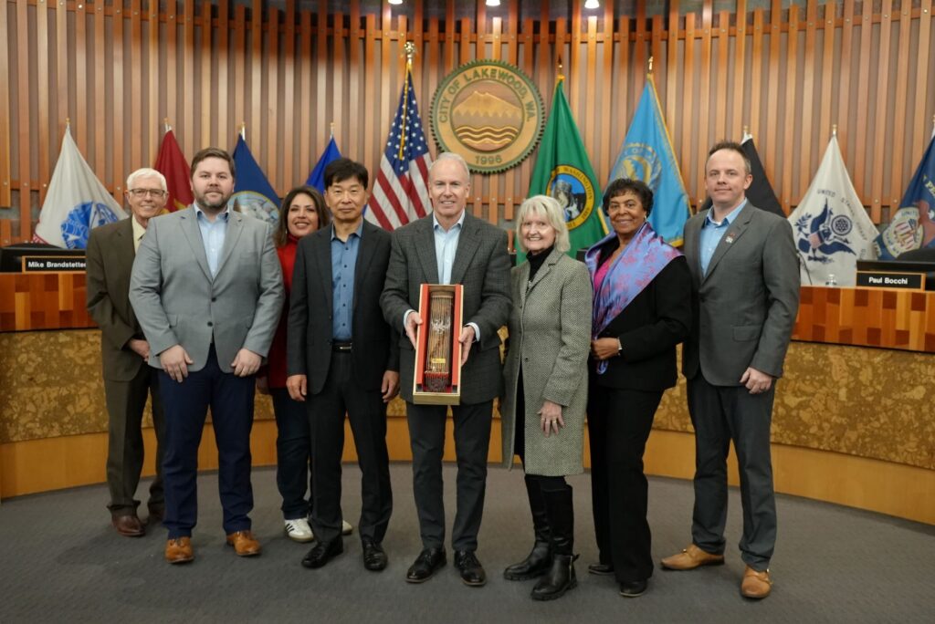 The Lakewood City Council pose with a gift from Sister City Gimhae, Republic of Korea and members of the Lakewood Sister Cities Association.