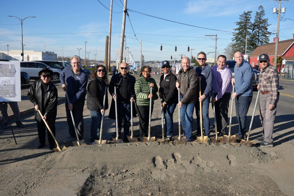 Members of the Lakewood City Council pose with Congresswoman Marilyn Strickland on South Tacoma Way with golden shovels for a groundbreaking event.